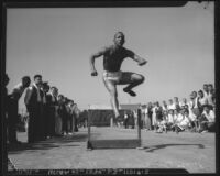 Jesse Owens jumps over a hurdle, Los Angeles, 1930s