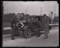 Stunt driver Hayward Thompson and his manager W. H. Watson inspecting his Pontiac Six, Los Angeles, 1927 