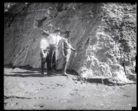 Three engineers or geologists examine a rock face after the collapse of the Francis Dam, San Francisquito Canyon (Calif.), 1928
