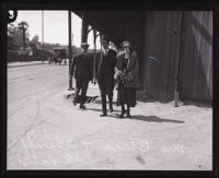 Fay Blair and Los Angeles Deputy Sheriff Norris Gilbert Stensland crossing the street, Los Angeles, 1924