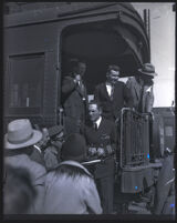 Commander Richard Byrd and his expedition members disembarking the back of a train car, Los Angeles, 1929