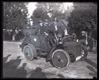 Pasadena firemen ride in a car in the Tournament of Roses Parade, Pasadena, 1924