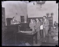 Convicted murderer Russell Beitzel and attorneys, including Vernon Hamilton, approach the judge's bench, Los Angeles, 1928