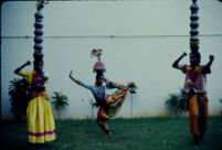 Om Periyaswamy dance troupe - Karakāṭṭam dance with a dancer in a karana pose as two dancers balance clay pots on their heads, Madurai (India), 1984