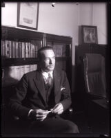 David H. Clark seated in an office, Los Angeles, 1931