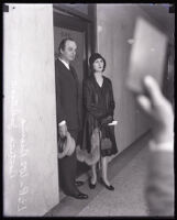 Former Julian Petroleum secretary Leontine Johnson and attorney William B. Beirne exit a courtroom, Los Angeles, 1928-1932