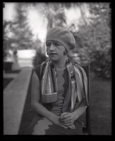 Millicent Sunday seated in a chair in a park or yard, Los Angeles, 1928 