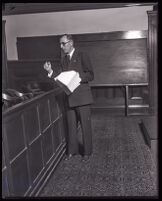 Buron Fitts standing in a courtroom, Los Angeles, 1920s 