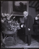 Cornelius Cole standing near bouquets of flowers, Los Angeles, 1924