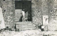 Unidentified person standing before the Main Gate of the Citadelle before restoration