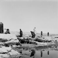 Bedouin women washing laundry at a water point