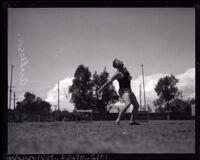 Track star Norm Anderson throws discus, Los Angeles, 1921-1928