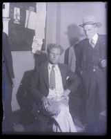Burton J. McKinnell waiting to be questioned at police headquarters, Los Angeles, 1931