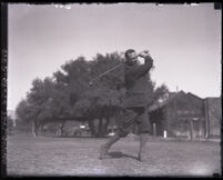Golfer Bill Bacon swinging a club at the Altadena Country Club, Altadena, circa 1932