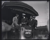Commander Richard Byrd and his expedition members stand at the back of a train car, Los Angeles, 1928