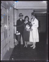 Daisy de Voe, former secretary of Clara Bow, departs a jail cell aided by her attorney William B. Beirne and matron Mabel Guilliams, Los Angeles, 1932
