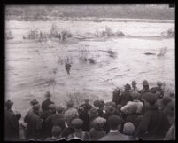Person being lifted out of the flooded San Gabriel River, El Monte, 1921