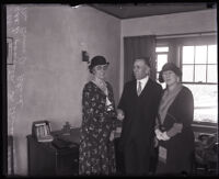 Dr. Bruce V. Black shaking hands with Ada D. Langston with his wife Mrs. Black on his side, Los Angeles, 1930