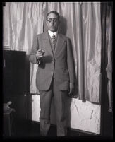 J. W. Randolph points to the camera in a full length portrait, Los Angeles, 1929