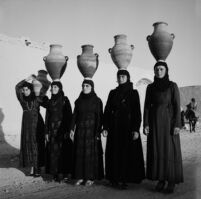 Village women carrying earthware jars