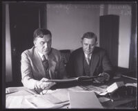 Daniel Beecher, chief trial deputy, and Reverend John Goben review documents, Los Angeles, 1929