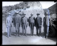 Six men wearing suits in the canyon after the collapse of the Saint Francis Dam, San Francisquito Canyon (Calif.), 1928