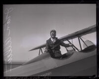 Pilot Jean Allen getting into the cockpit of a biplane, Los Angeles, 1923-1930