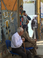 Voting in Sulaimani, two old man sitting on chairs next to the school main gate
