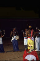 Theyyam festival - Thirayāṭṭam performer and musicians behind microphones, Kalliasseri (India), 1984