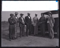Aviators William M. Breingan and Walter F. Parkin with 5 men at an airfield, Los Angeles County, 1920s