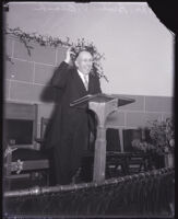 Dr. Bruce V. Black speaking from behind a lectern, Los Angeles, 1931