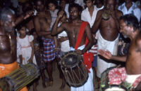 Kunyāttu Kārnavar playing a kuzhal, a double-reed wind instrument, Pengamuck (India), 1984
