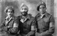 Studio portrait of three Indian soldiers in the British Army's 8th infantry division