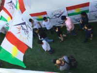 Entrance of the stadium with Kurdish flags, and "No for Now" flyers