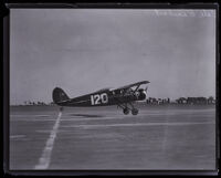 Stinson "S" Junior airplane landing on a runway, California, 1926-1932