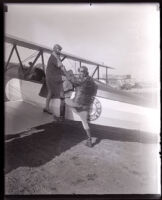 Pilots Josephine Callaghan and Charles F. Dycer in front of a biplane at Dycer airport, Los Angeles, 1929