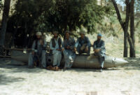 Mujahideen With Their Gun Sits on Unexploded Rocket