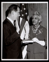 Supervisor Kenneth Hahn administering a pledge from Dr. Vada Somerville, Los Angeles, 1950s-1960s