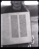 Gutenberg Bible page held by a Sadie Fox, Los Angeles, 1928