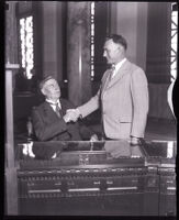 Los Angeles Councilmen William G. Bonelli shaking hands and Evan Lewis, Los Angeles, 1927-1929