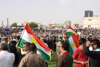 People holding a Kurdish flag