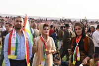 People holding Kurdistan flag