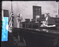 Frances Askam swearing in as a witness in actor Paul Kelly's murder trial, Los Angeles, 1927