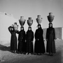 Village women carrying earthware jars