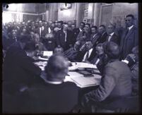 Secretary to the Chief of Police Ralph S. Boyesen seated at the head of a full table surrounded by men, Los Angeles , 1923