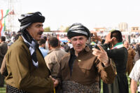 Two men wearing Kurdish clothing