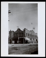 Corner on an unpaved commercial street, Los Angeles, 1882-1920
