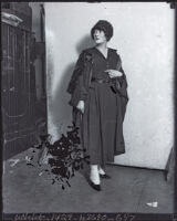 Jane Anderson, writer, stands at a doorway, Los Angeles, 1918