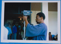 Wally Serote filming with Super- 8 camera at National Museum and Art Gallery, Gaborone, Botswana, 1980