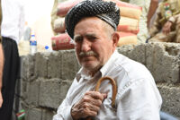 An old man, tearing up while listening to the patriotic songs
